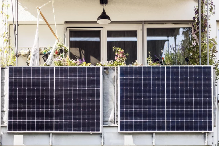 Two solar panels that a homeowner creatively mounted on the outer side of a garden balcony.
