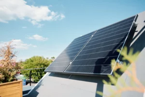 A pair of newly cleaned solar panels that are mounted on a roof.